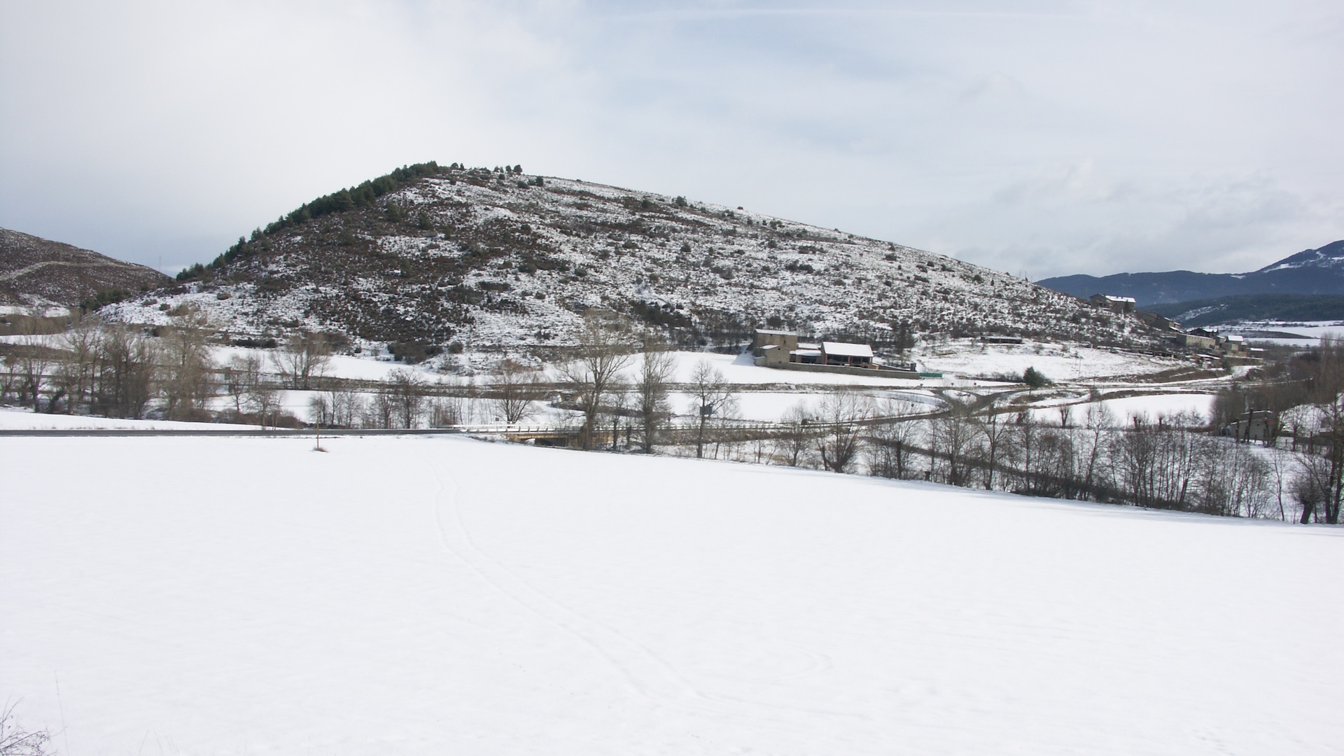 A small hill at high elevation in the Pyrenees mountain range.