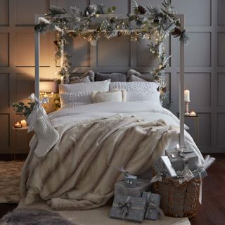 Christmas bedroom with four poster bed and garland