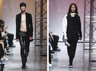 Woman and man in black coloured fashion on a ramp walk