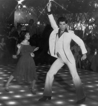 John Travolta as Tony Manero in his famous disco-dancing pose in Saturday Night Fever (1977).