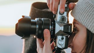 Photographer using the OM System OM-3 in an outdoor environment