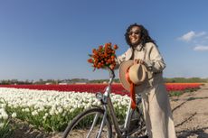 Tourists go on holiday cycling in a tulip field
