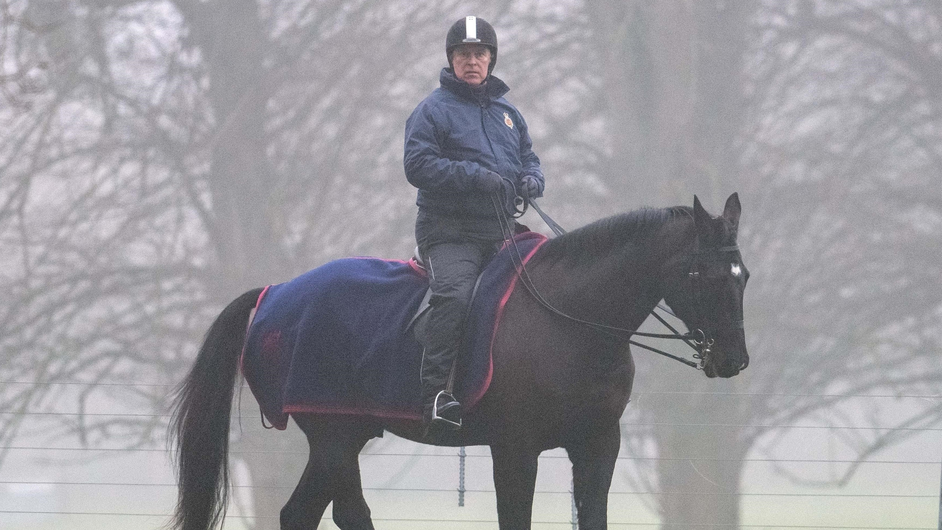 Ex-Prince Andrew rides on his horse during a foggy morning in Windsor