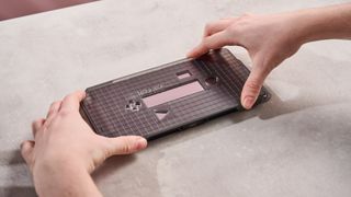 Person placing application frame on the Genki Aegis Shield