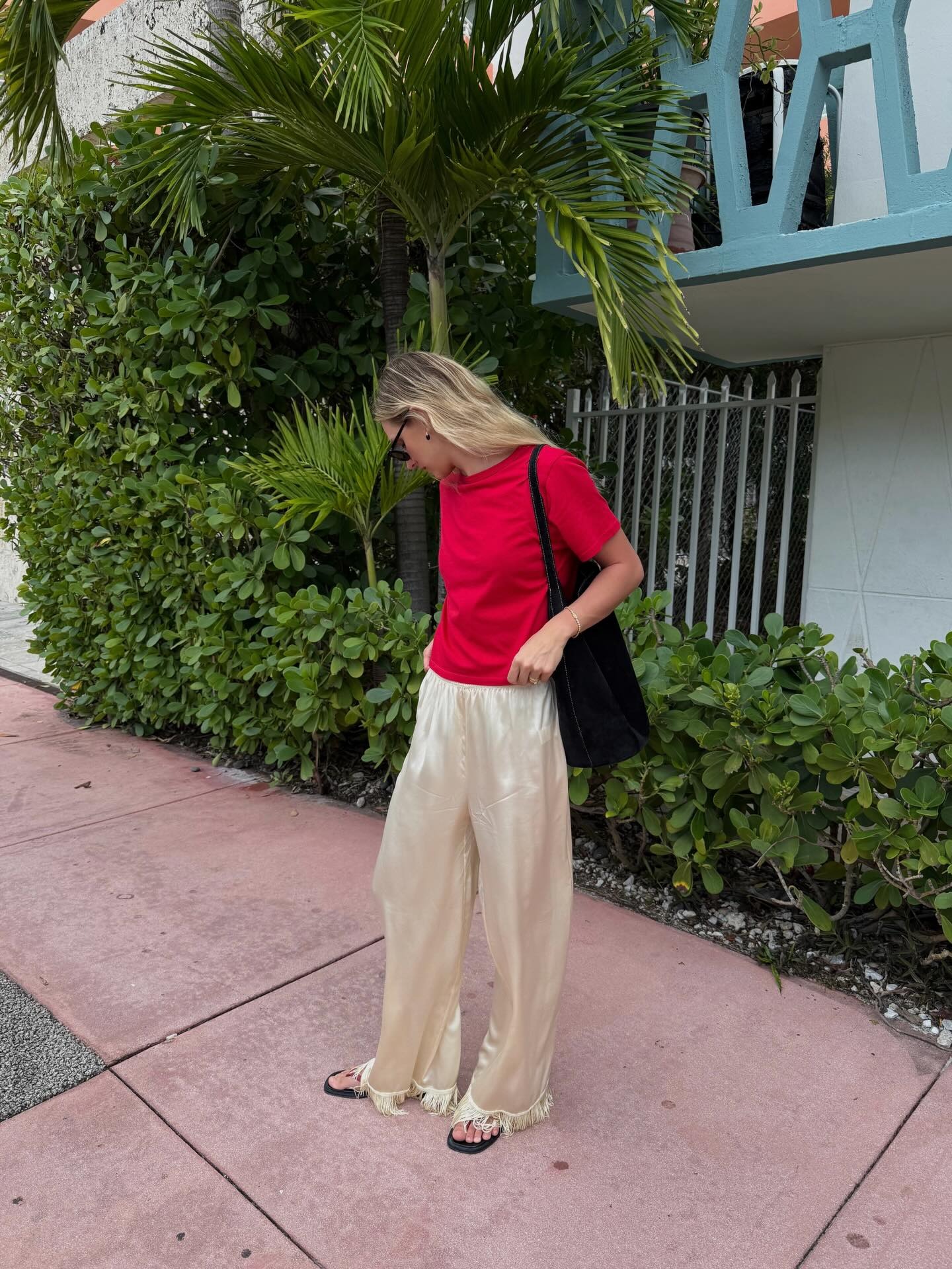 Woman in satin pants and red t-shirt
