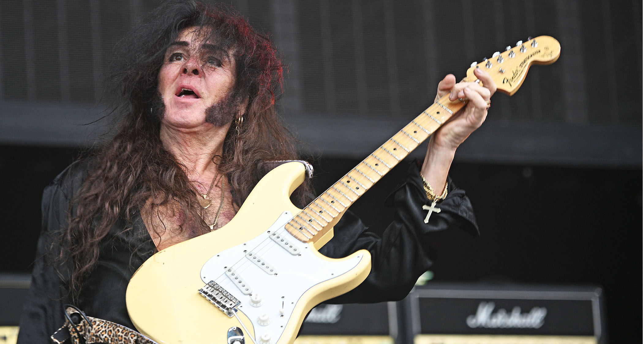 Yngwie Malmsteen frets a chord and holds it during his set at Wacken 2026.