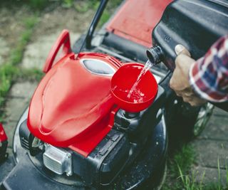 Adding fuel to a lawn mower