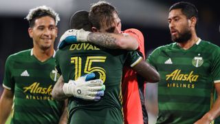 Portland Timbers goalkeeper Steve Clark and defender Chris Duvall embrace after defeating the Philadelphia Union in the MLS is Back tournament on August 5, 2020, at the ESPN Wide World of Sports Complex in Orlando, FL.