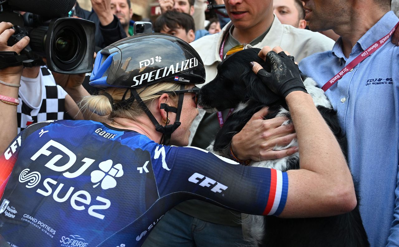 Vollering celebrates with her dog Flo at the finish