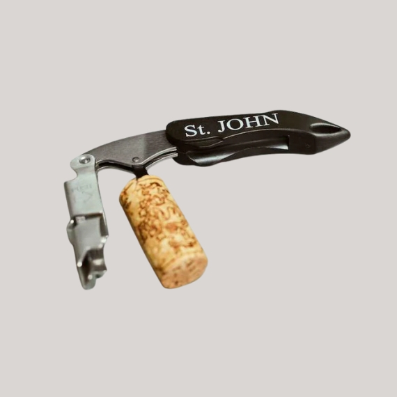 A black wine opener with a cork still attached to it reads "St. JOHN" in white characters against a pale grey background.