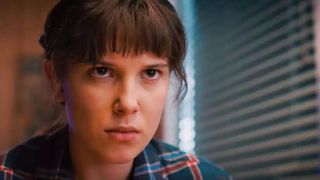 Eleven (Millie Bobby Brown) stares in a diner in the Stranger Things 4 trailer