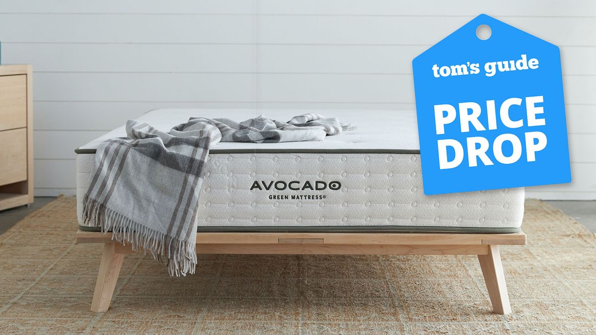 The Avocado Green Mattress on a simple wooden bed frame in a bedroom, a Tom&#039;s Guide price drop deals graphic (right)