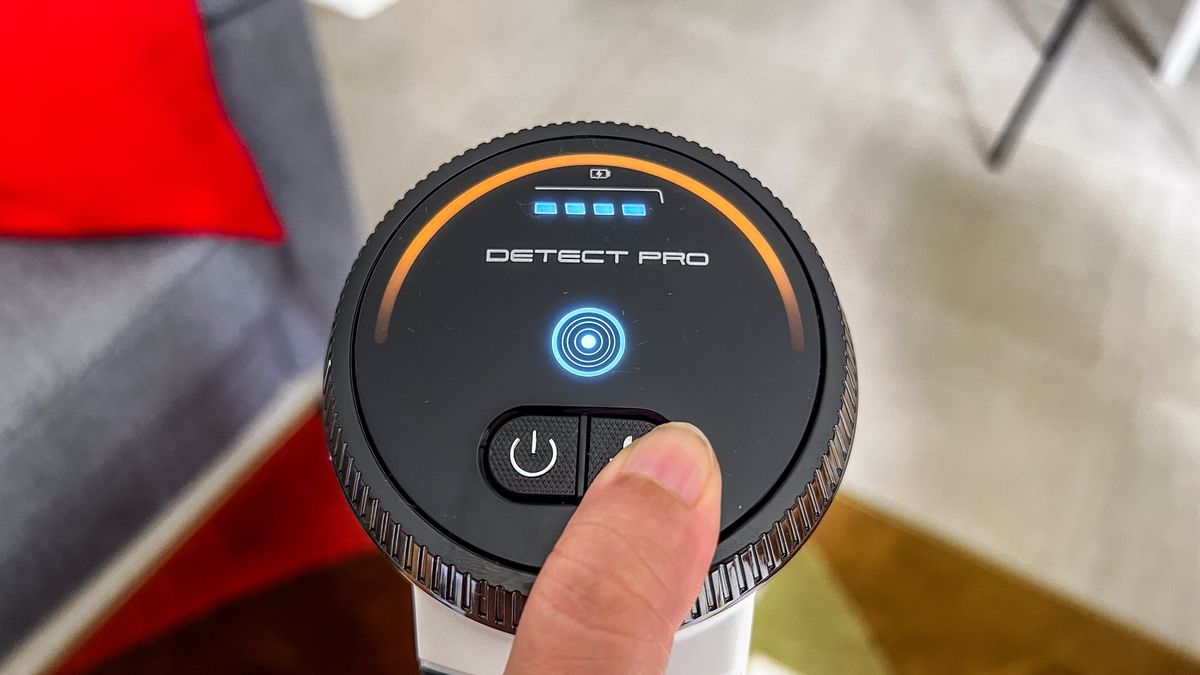 A finger on the suction mode button of the Shark Cordless Detect Pro