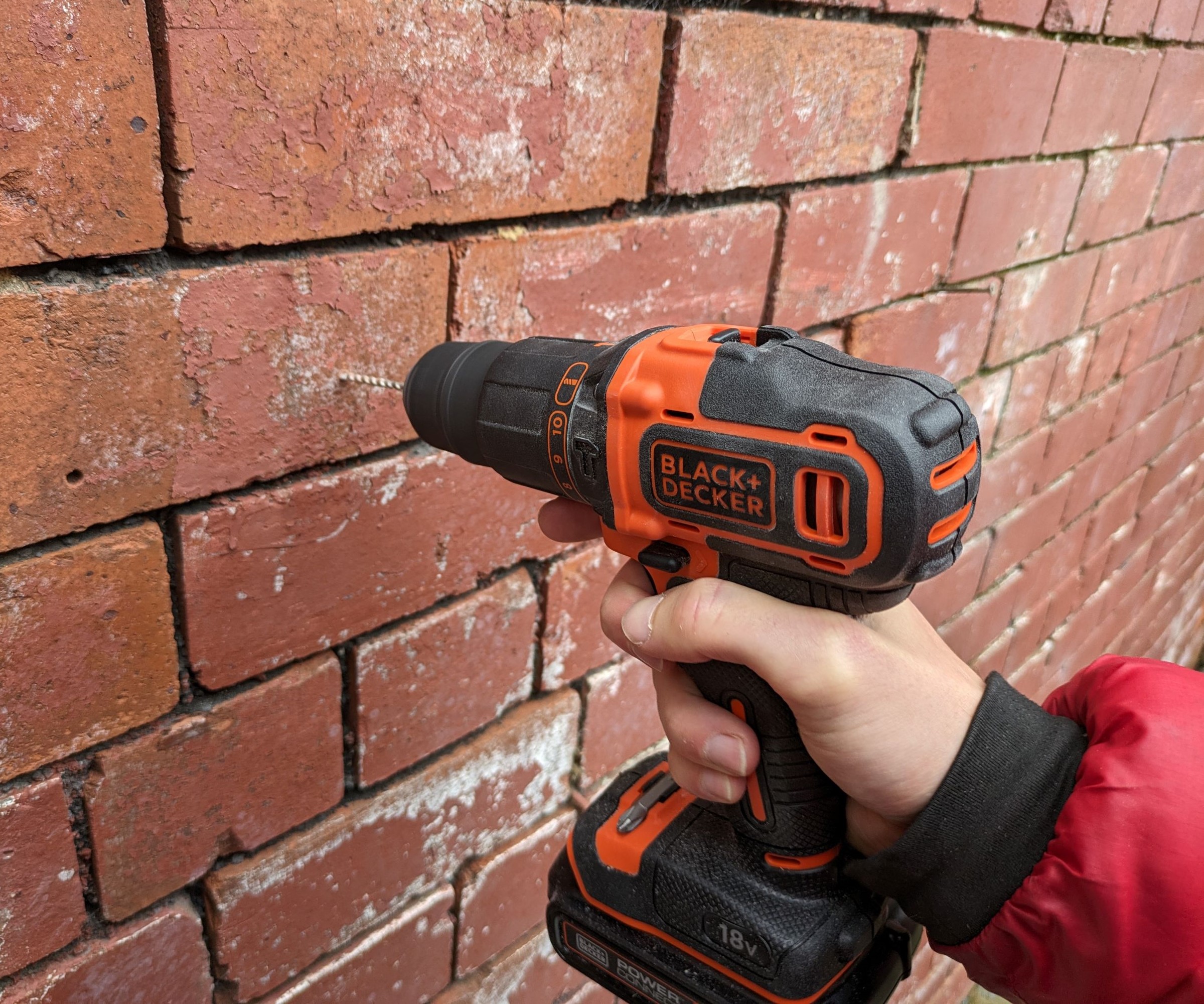 Black & Decker combi drill drilling into brick