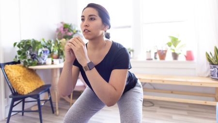 woman does bodyweight squat