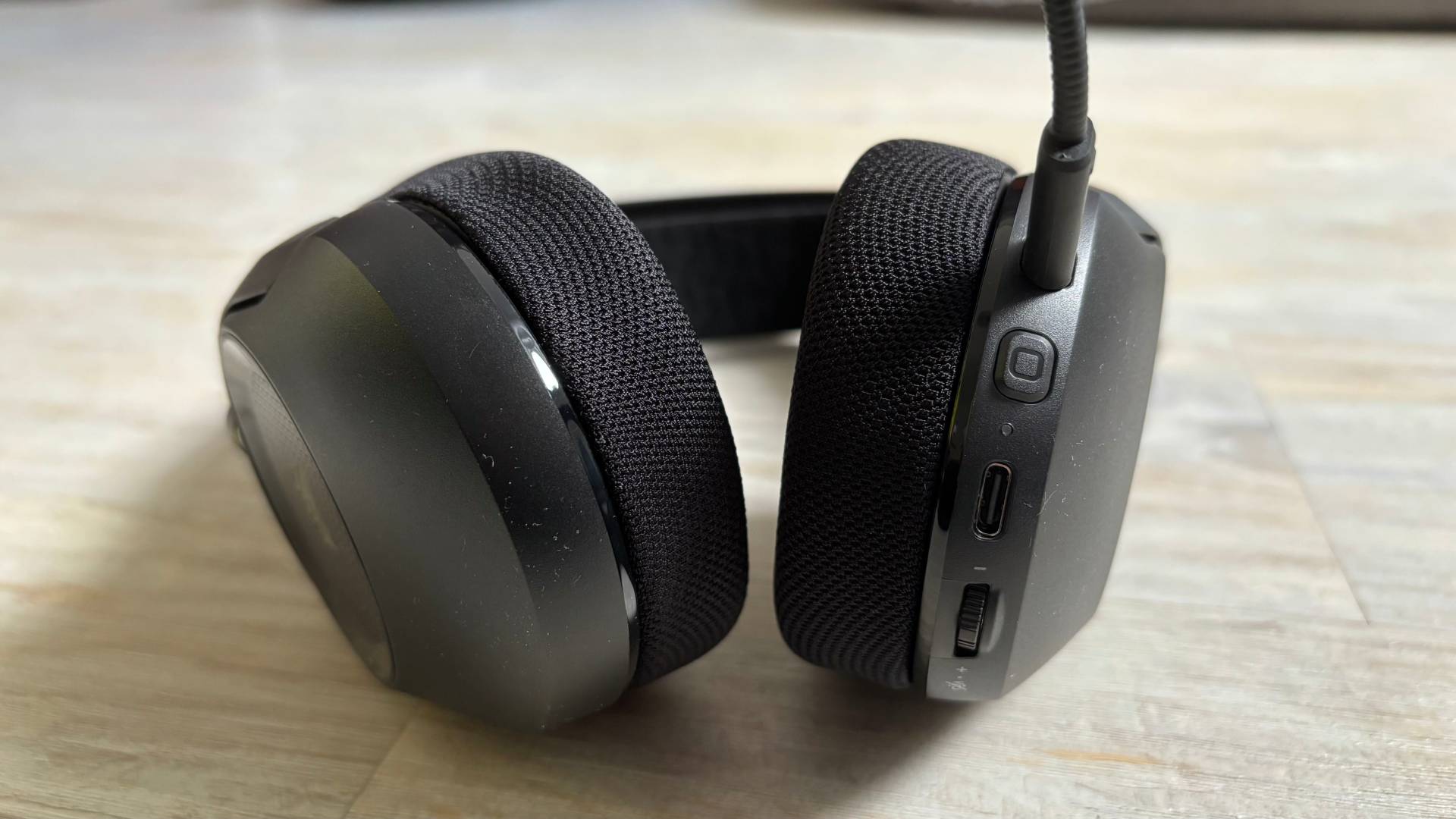 Close up of the Corsair HS35 v3 headset ear cups on a white hardwood background
