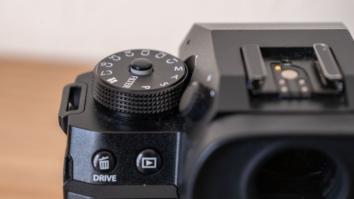 A close-up of the mode dial on a Fujifilm X-H2.