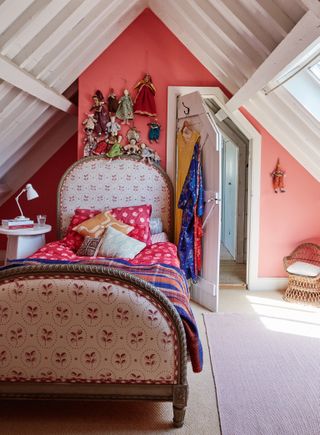 child's room with pink walls in attic with antique French bed in converted barn