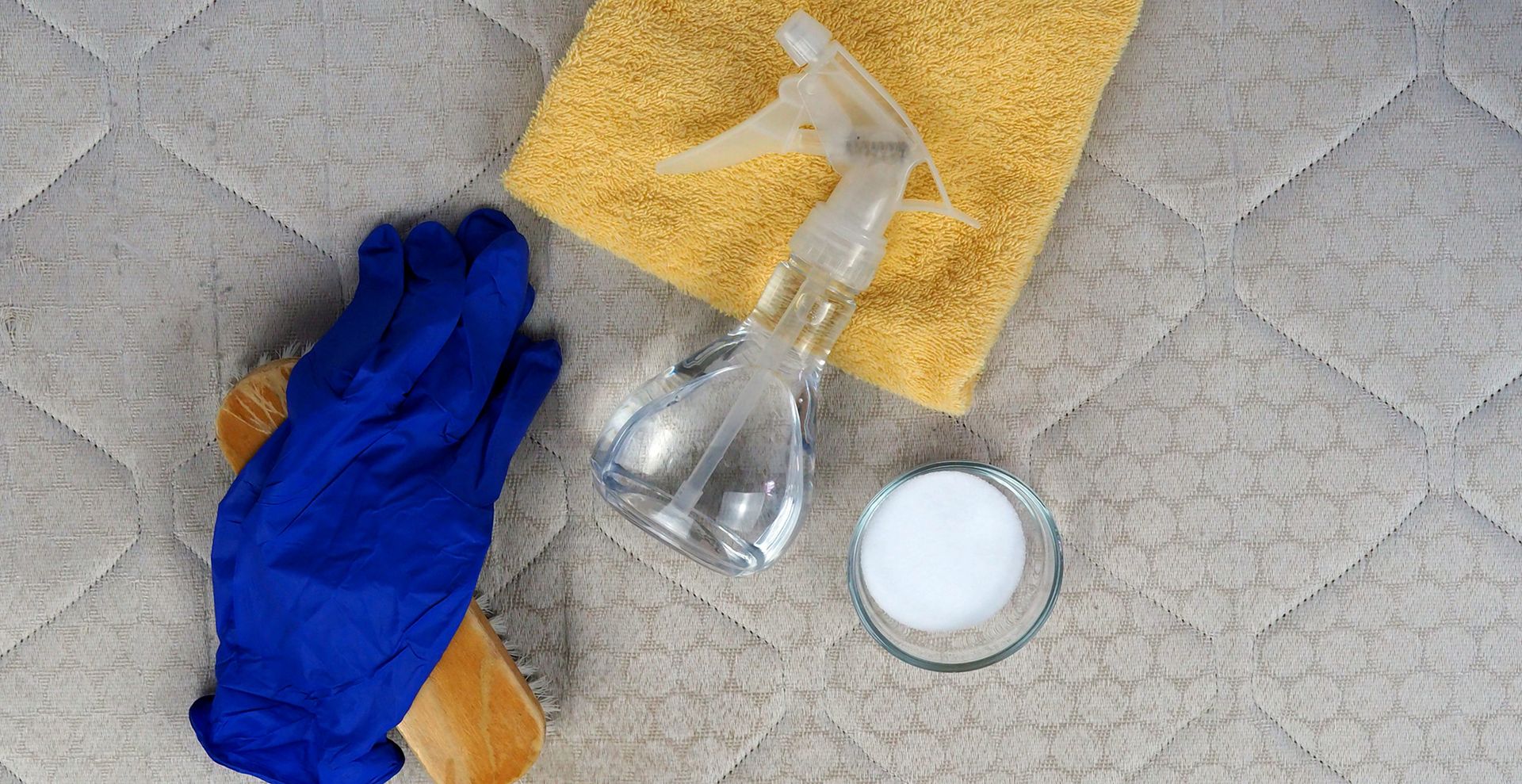 natural ingredients on top of a mattress to show how to deep clean a mattress with ease