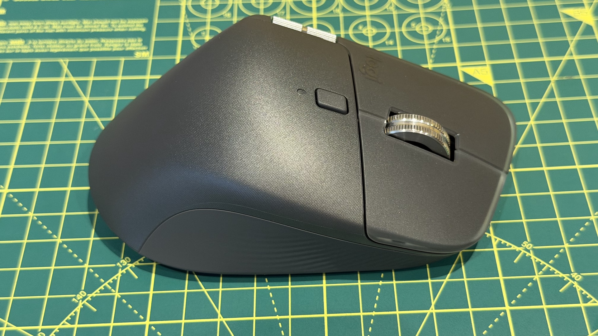 The Logitech MX Master 4 mouse on a graphing grid
