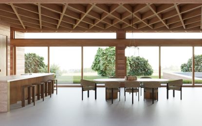 View looking out to green landscape from glazed wall of timber house