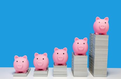 Pink piggy banks on ascending stacks of paper currency.
