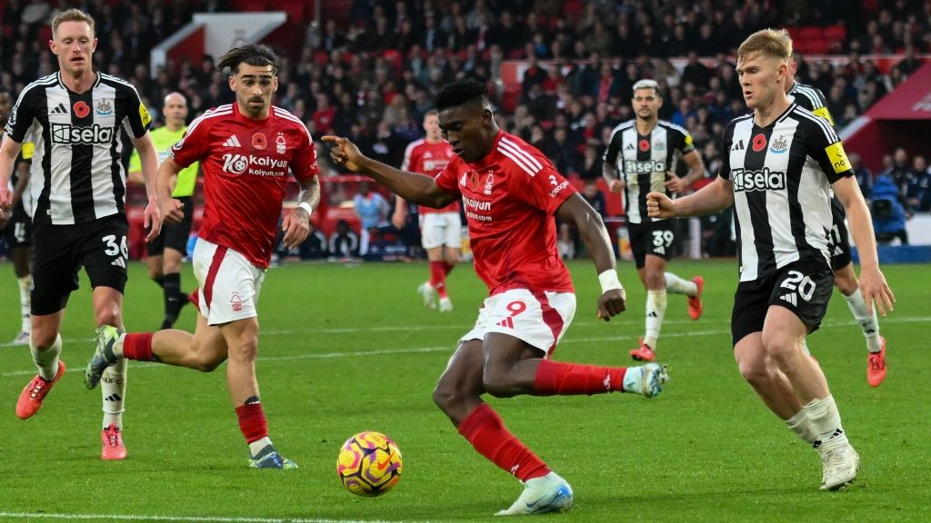 Taiwo Awoniyi of Nottingham Forest is under pressure from Lewis Hall of Newcastle United during the Premier League match between Nottingham Forest and Newcastle United at the City Ground in Nottingham, United Kingdom, on November 10, 2024.