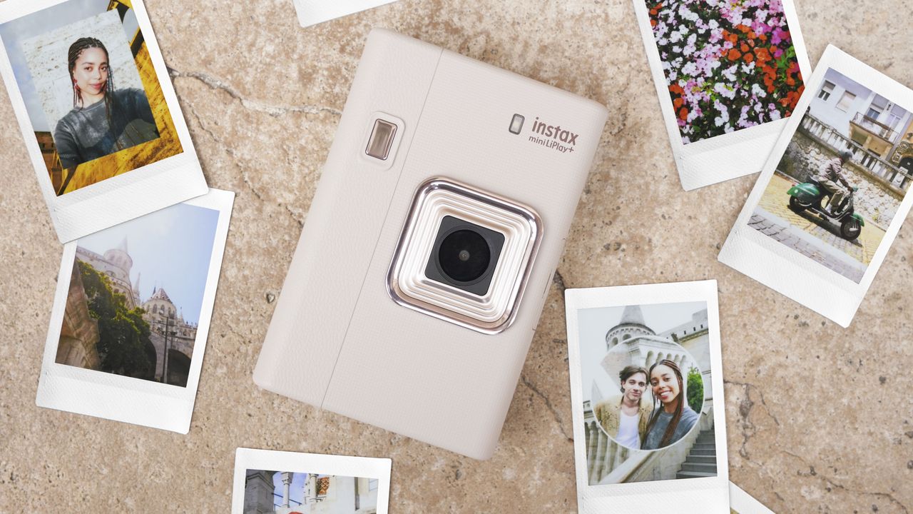 Fujifilm Instax mini LiPlay+ hybrid instant camera on a marble surface surrounded by instant prints