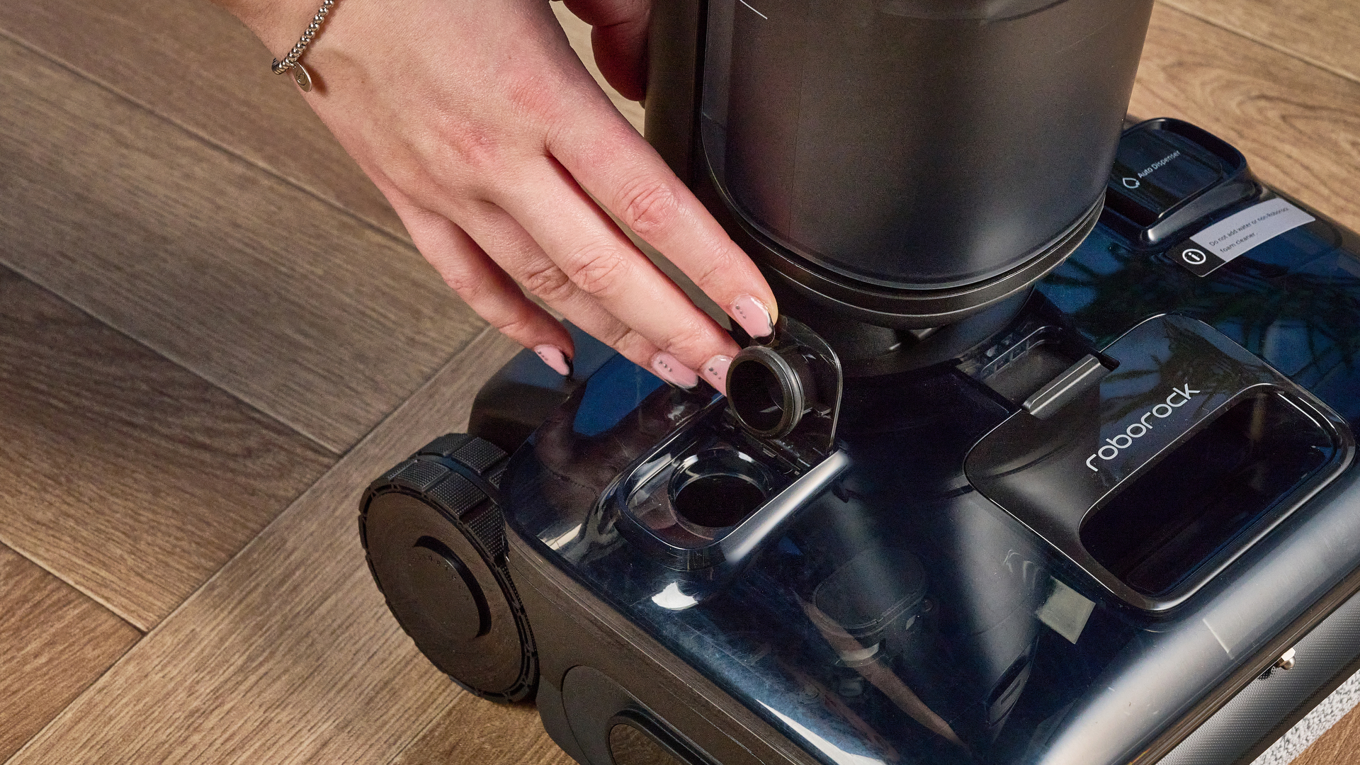 clean water tank of the Roborock F25 ACE Pro photographed on a brown woodn floor