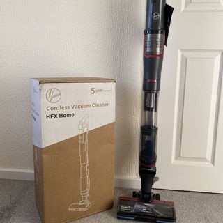 Hoover HFX cordless vacuum next to box