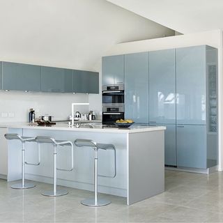 spacious kitchen with glossy sea-blue cabinetry