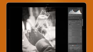 Hand holding a champagne glass in a Lightroom preset