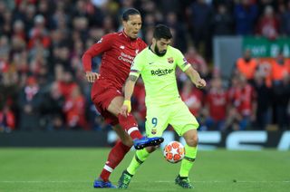 Liverpool’s Virgil van Dijk (left) and Barcelona’s Luis Suarez battle for the ball during the UEFA Champions League Semi Final, second leg match at Anfield, Liverpool