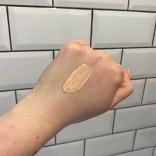 Lucy's hand showing swatch of Charlotte Tilbury Hollywood Flawless Filter in Shade 1