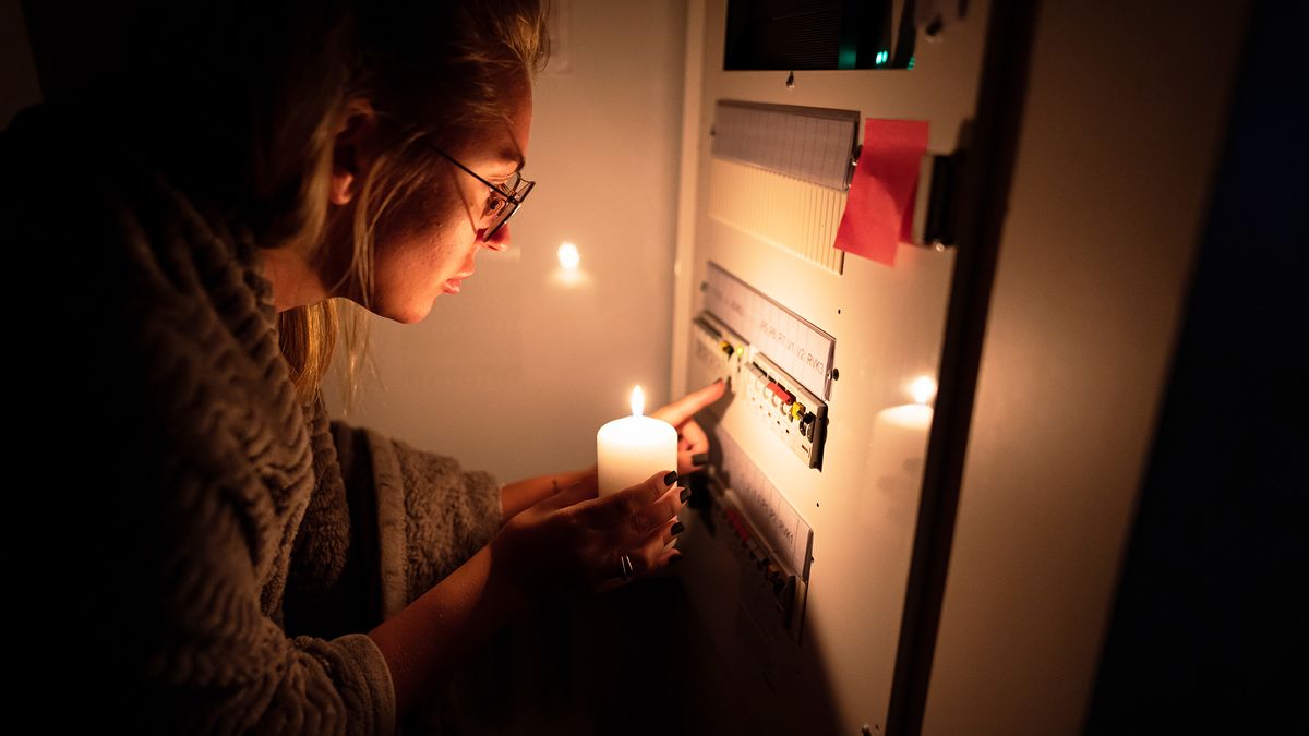 A person checking breakers during a power outage