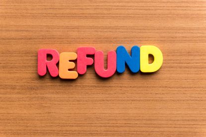 Colourful letters spelling the word refund on a wooden table