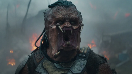 Screenshot from Predator Badlands showing the Predator snarling with teeth exposed and mandibles spread wide.