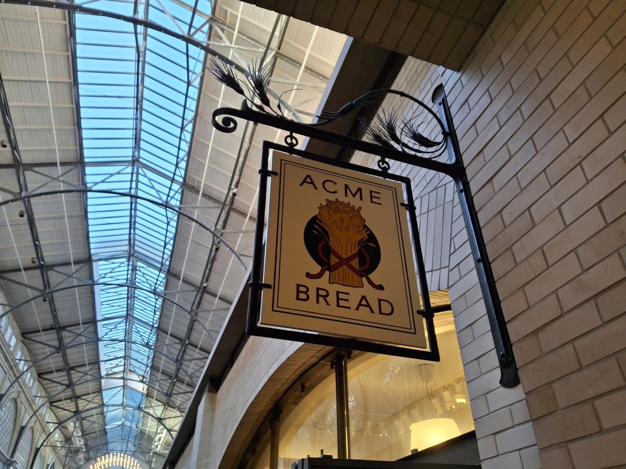 photo of Acme Bread sign in indoor market shot by Galaxy A35