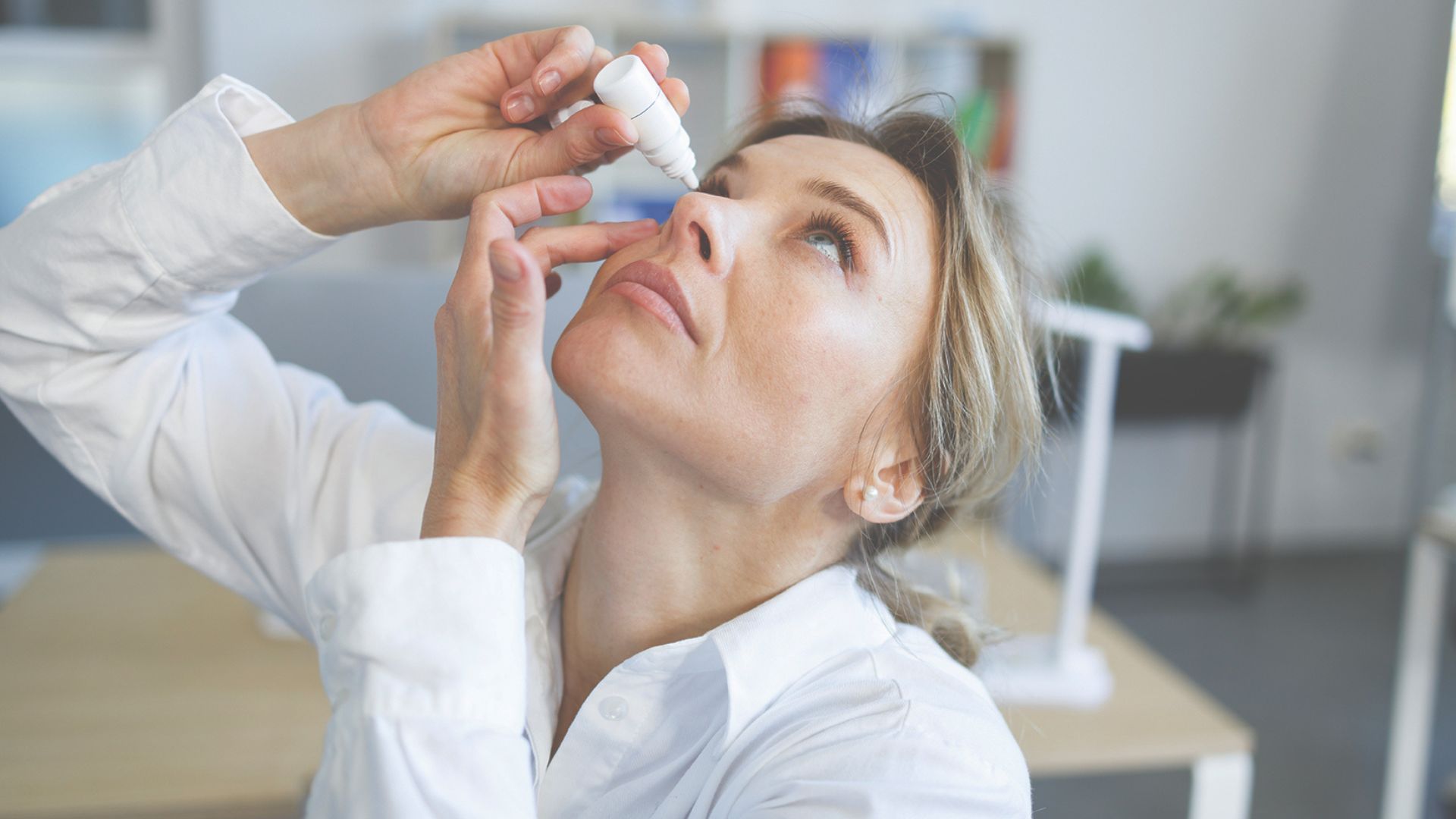 Woman using eyedrops
