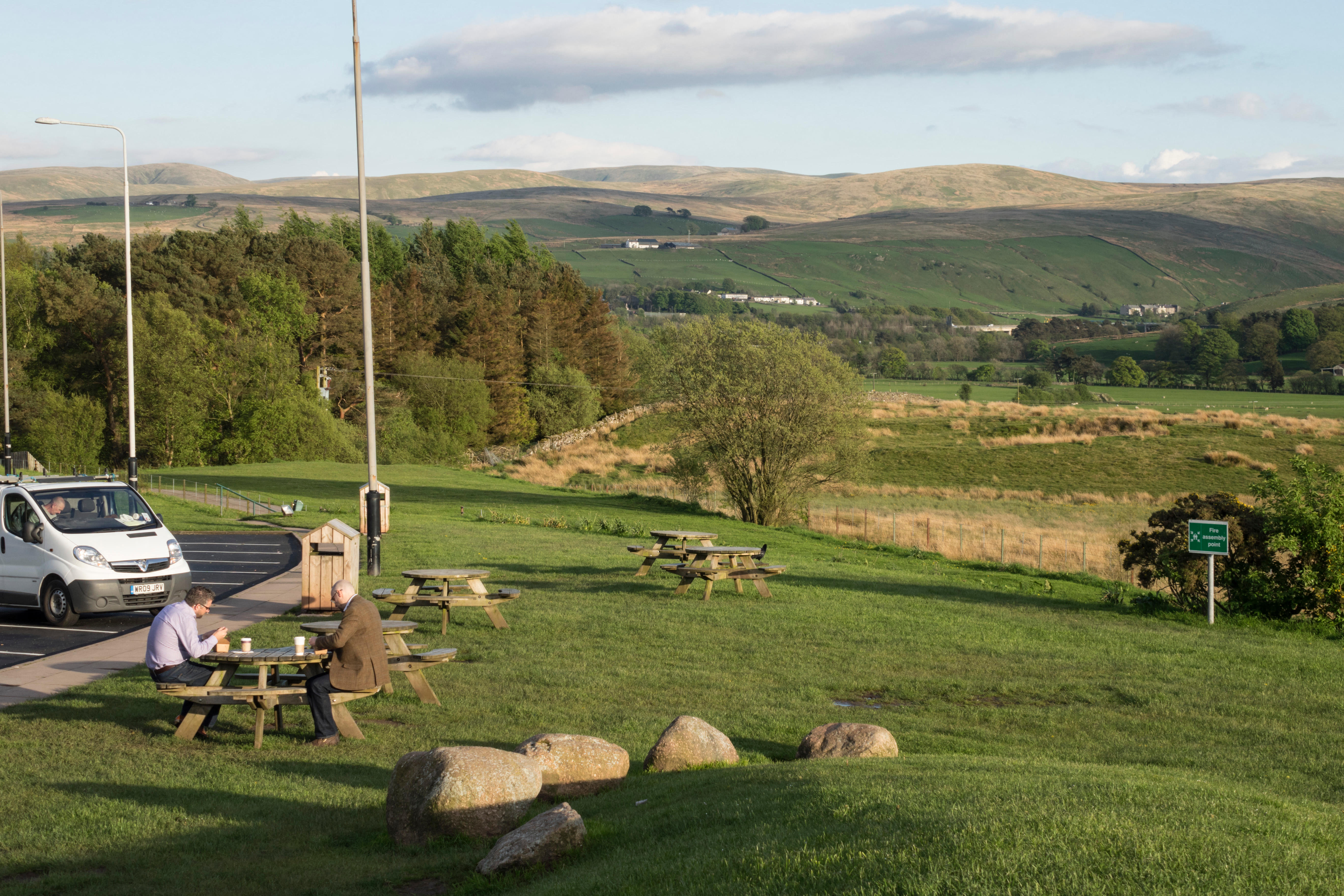 Tebay Services, south Cumbria - award winning M6 motorway services, restaurant and farm shop. Having a coffee in evening sun.