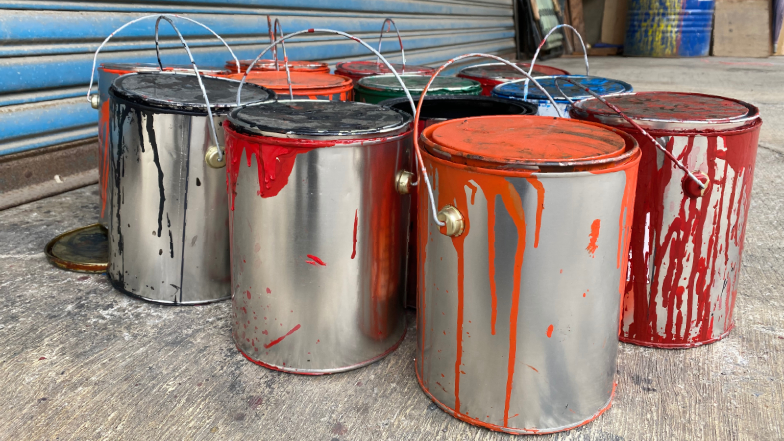 tins of paint stood on garage floor