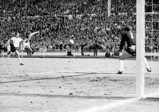 Sir Geoff Hurst fires home his hat-trick goal in the 1966 World Cup final