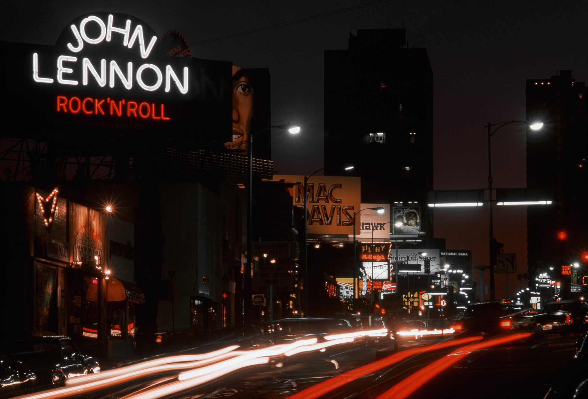A view of the Sunset Strip looking west with billboards for John Lennon &#039;Rock &#039;N&#039; Roll&#039;, Michael Jackson &#039;Forever, Michael&#039;, Mac Davis &#039;Burnin&#039; Thing&#039;, David Bowie &#039;Young Americans&#039; and the nightclub Filthy McNasty&#039;s in April 1975 in Los Angeles, California.