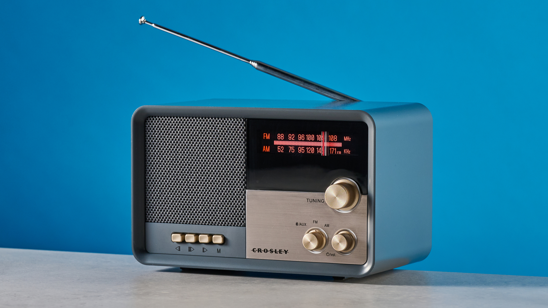Crosley Tribute Radio in gray color photographed on a blue background