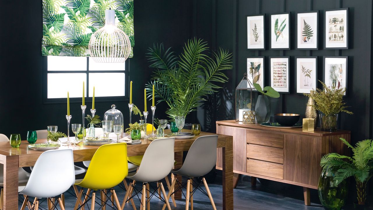 Black dining room with wall panelling, gallery wall and botanical theme