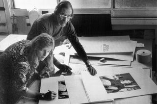 Photographer Linda McCartney signs copies of her limited edition portfolio silkscreen prints at Kelpra Studios, London, watched by master printer Chris Prater. This picture was taken by Paul McCartney, Linda's husband, and her colleague in the musical group "Wings."