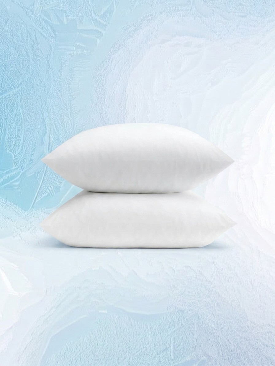 A set of two pillows in Coop Cool+ Pillowcases against a blue icy background edited by Gemini