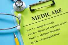 Papers about types of medicare insurance and a stethoscope.