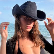 Hailey Bieber on the beach with lemon yellow nails