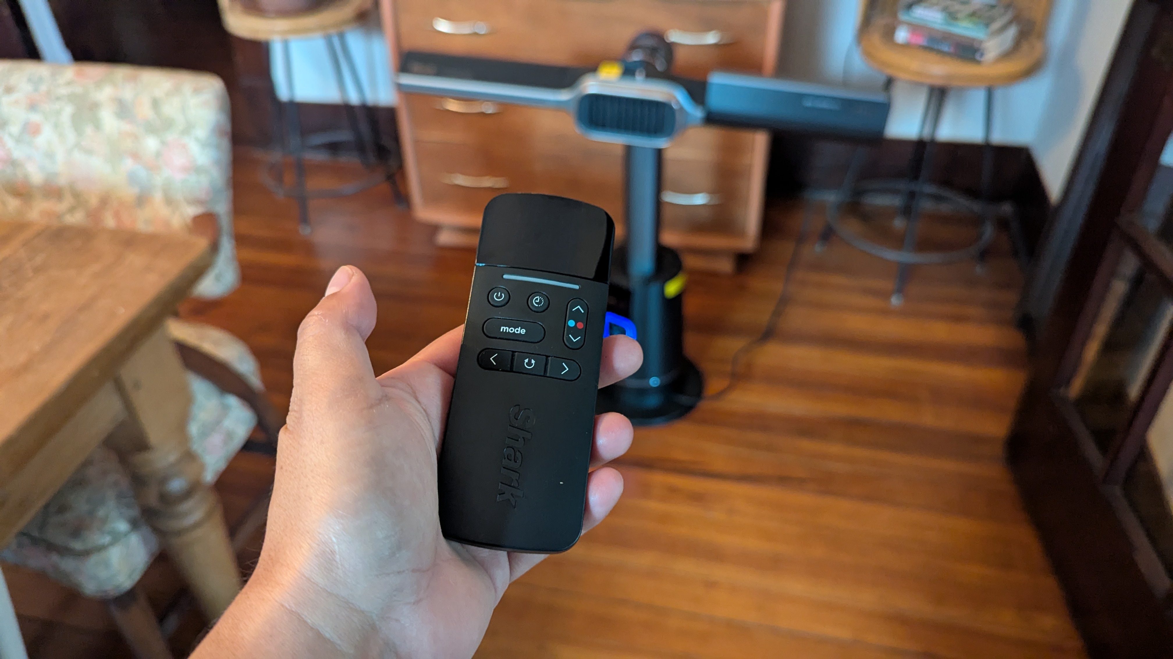 Tester controlling the Shark TurboBlade Cool + Heat with remote